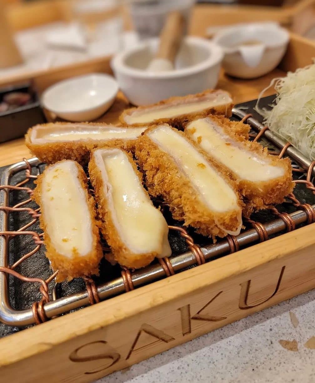 Sliced cheese katsu on a grill plate