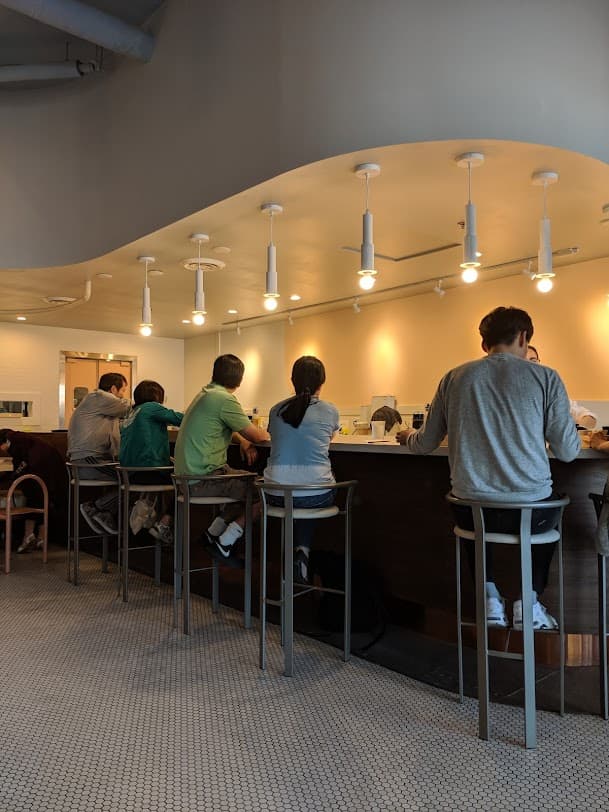 People sitting and eating inside a restaurant